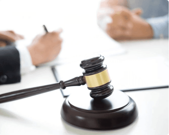 Judge sitting at desk with another person.